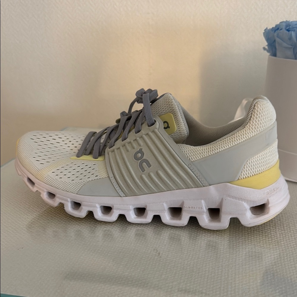 On Running White and Yellow Athletic Shoes